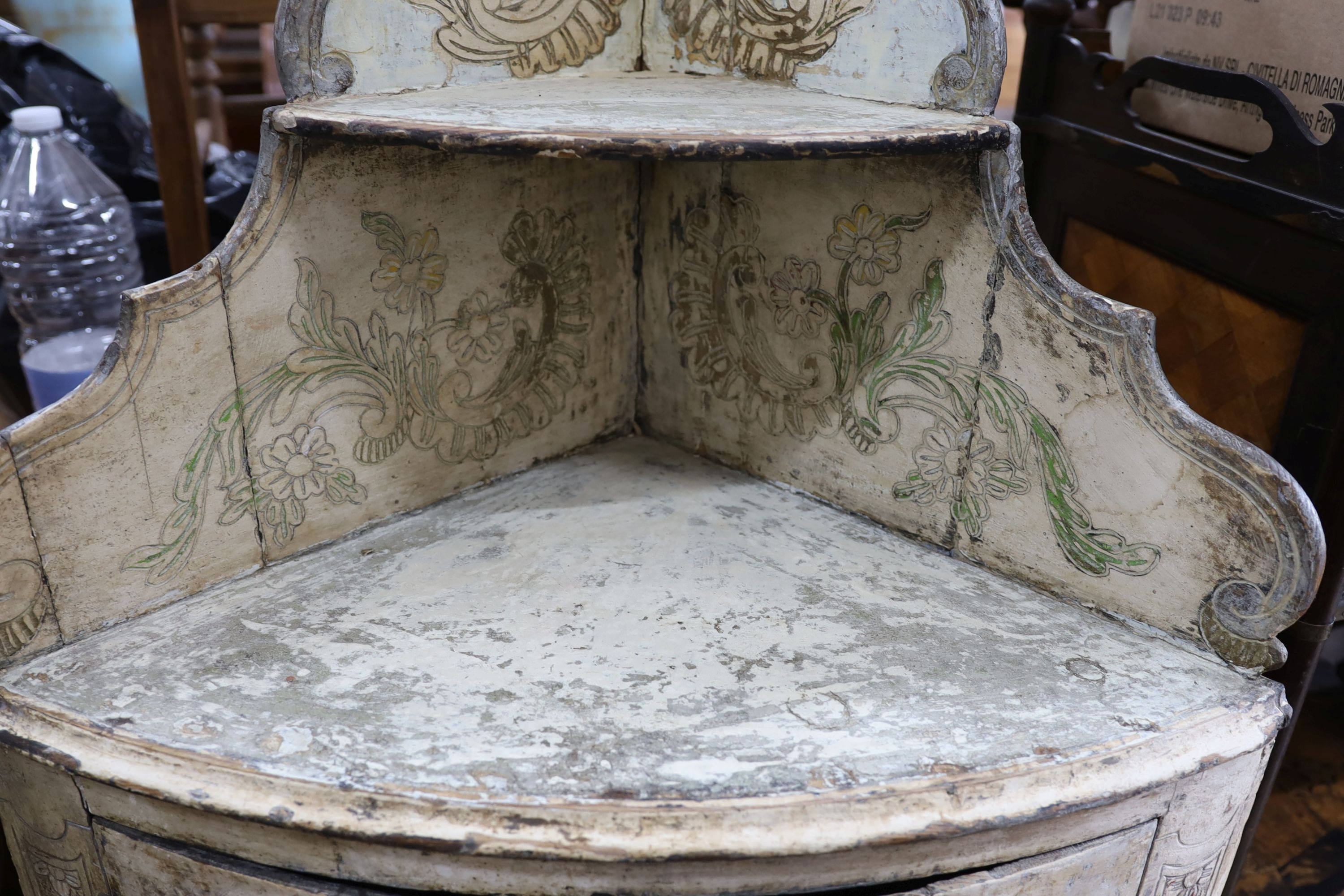 An 18th century Italian painted carved pine bow front standing corner cabinet, width 64cm, depth 38cm, height 145cm